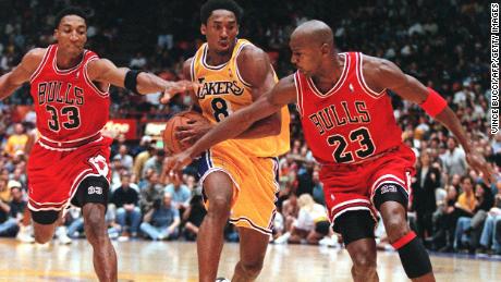 Pippen and Jordan try to stop Kobe Bryant in a game in February 1998.