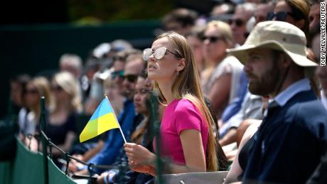 A spectator holds a Ukrainian flag at last year&#39;s Wimbledon. 