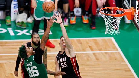 Boston Celtics guard Marcus Smart (36) and Miami Heat forward Duncan Robinson (55) reach for a rebound during the second half in Game 7 of the NBA basketball Eastern Conference finals Monday in Boston. 