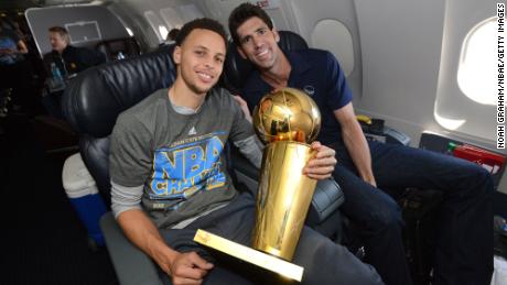 Bob Myers and Steph Curry celebrate with the NBA trophy after winning the 2015 NBA Finals.