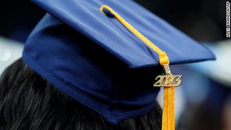 A tassel with 2023 on it rests on a graduation cap as students walk in a procession for Howard University&#39;s commencement in Washington, Saturday, May 13, 2023.