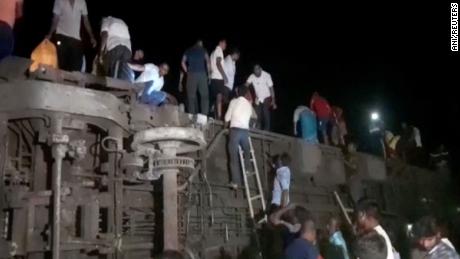 People try to escape from toppled compartments, following the deadly collision of two trains, in Balasore, India June 2, 2023, in this screen grab obtained from a video. 