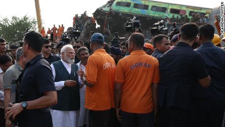 Modi speaks to officials and rescue workers at the site.