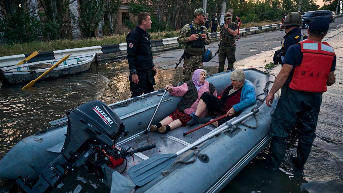 Rescue workers attempt to tow boats carrying evacuated residents on June 6.
