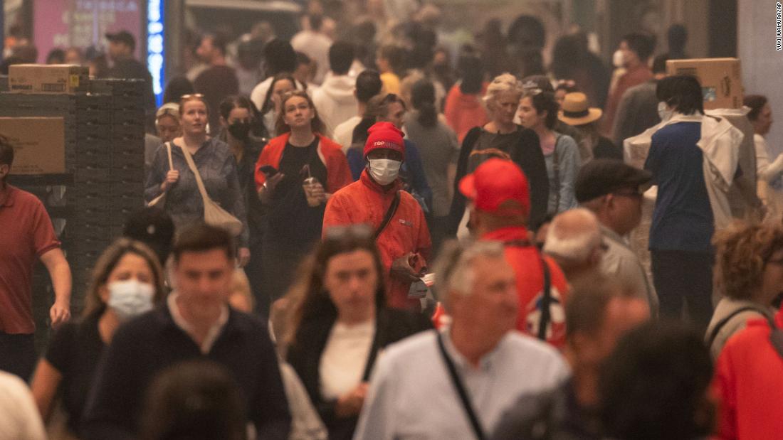 People wear face masks as they walk in New York&#39;s Herald Square on June 7.