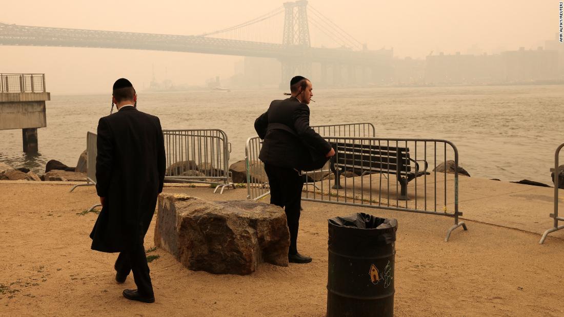 Two men stand by the waterfront in Brooklyn, New York, on June 7.