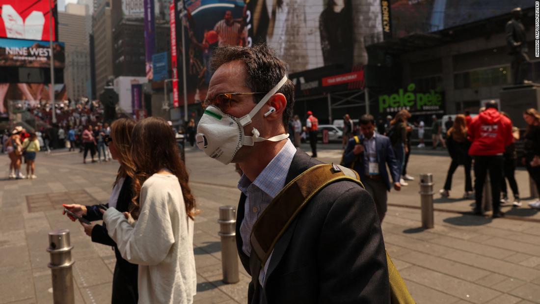 A man wears a protective face mask while walking through Times Square in New York on June 8.