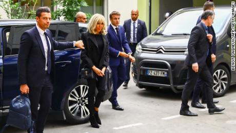 President Emmanuel Macron (center) and his wife Brigitte Macron (second left) arrive at a hospital in Grenoble on Friday to visit the victims the stabbing incident.