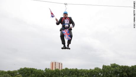 Boris Johnson gets stuck on a zip-line in Victoria Park in London where the 2012 Olympic Games were being shown on a big screen on August 1, 2012.