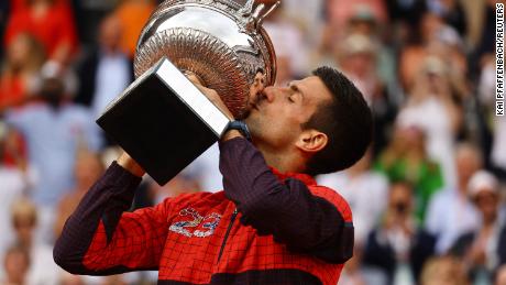 Serbia&#39;s Novak Djokovic kisses the trophy after winning the French Open.