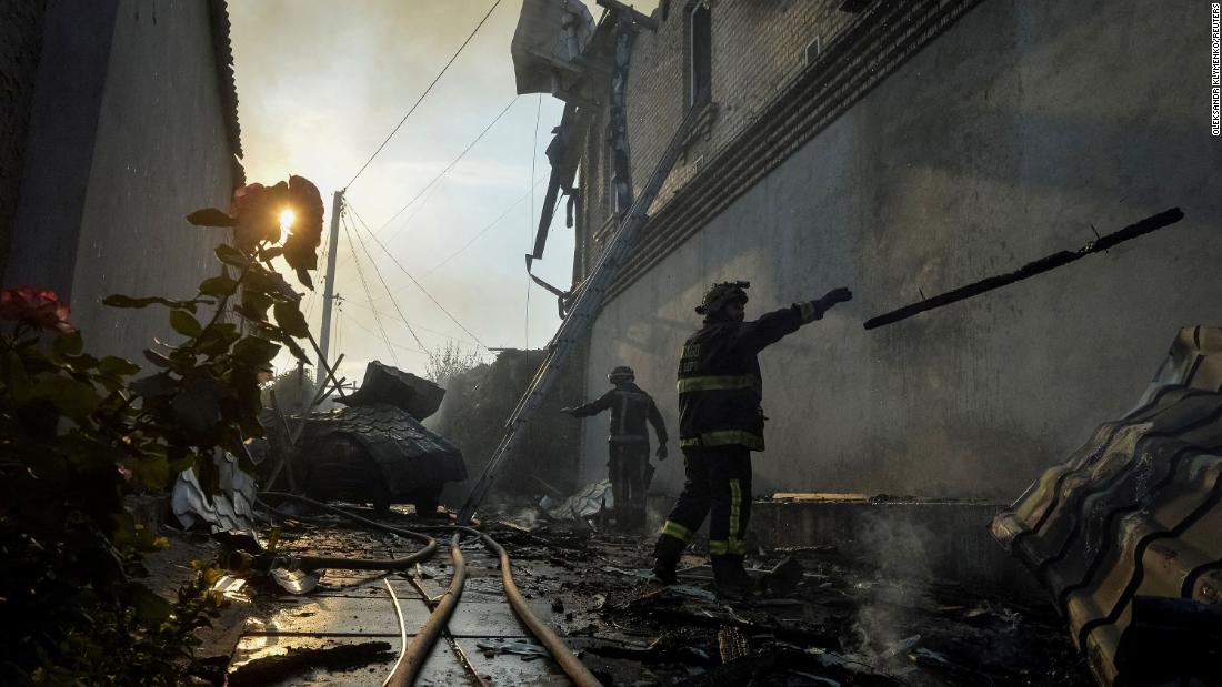 Emergency workers respond to a house damaged after Russian shelling in Kherson on June 9.
