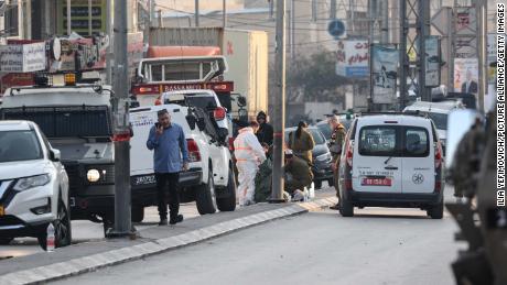 Israeli security forces  respond to the scene of the shooting attack that killed the Yaniv brothers.