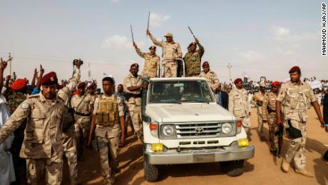 Gen. Mohamed Hamdan Dagalo (Hemedti) waves to a crowd during a rally in the Nile River State, Sudan, on July 13, 2019. 