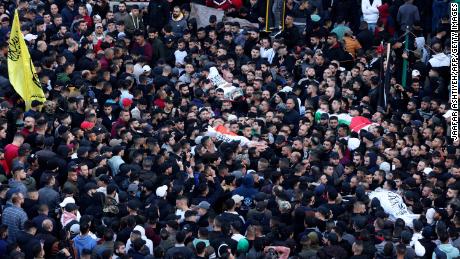 Mourners carry bodies of Palestinians killed in a raid by Israeli forces in Nablus, during their funeral on February 22.