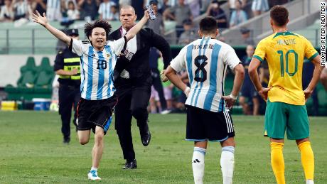 The young pitch invader is chased by security officials during a soccer match between Argentina and Australia at the Workers&#39; Stadium in Beijing, China, on June 15.