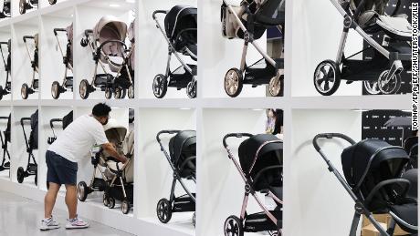 A man looks at strollers at a baby fair in Seoul, South Korea, in September 2022. South Korea&#39;s fertility rate is the lowest in the world.