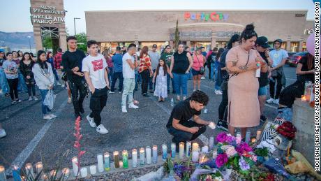 Mourners light candles during a vigil for Alexia Rael and her cousin Mario Salgado-Rosales on May 10, 2022, in Albuquerque, New Mexico.