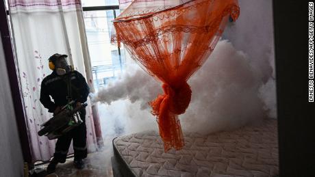 A worker fumigates a house against the Aedes aegypti mosquito to prevent the spread of dengue fever in a neighborhood in Piura, northern Peru, on June 11, 2023.