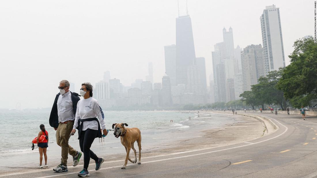 People in Chicago walk along the shoreline of Lake Michigan on June 27.