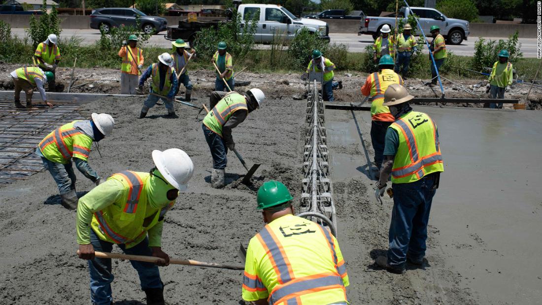 Construction crews work to repair a Houston road that was damaged by the extreme heat.