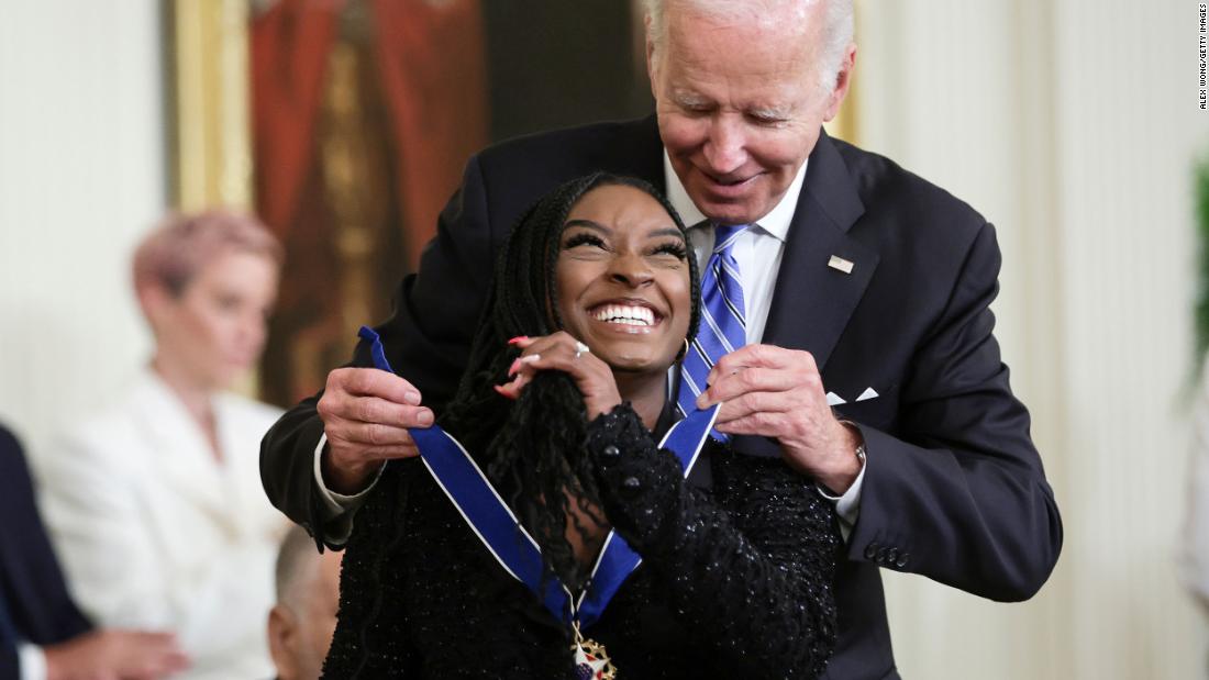 President Joe Biden awards Biles with the Presidential Medal of Freedom in July 2022. Biles, 25, became &lt;a href=&quot;https://www.cnn.com/2022/07/07/politics/biden-presidential-medal-of-freedom/index.html&quot; target=&quot;_blank&quot;&gt;the youngest person ever to receive the award&lt;/a&gt;. &quot;When she stands on the podium,we see what she is: absolute courage to turn personal pain into a greater purpose, to stand and speak up for those who cannot speak for themselves,&quot; Biden said.