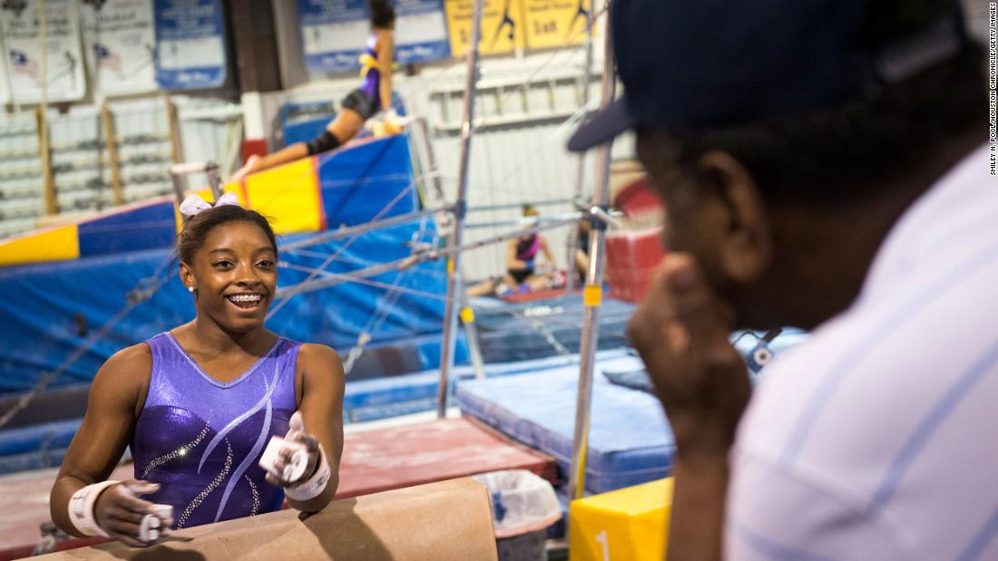 Biles talks with her grandfather, Ron, as she trains in Houston in August 2013. Biles grew up in Spring, Texas, just outside of Houston.