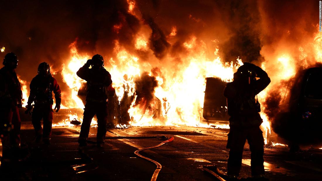Firefighters extinguish burning vehicles during clashes in Nanterre on Wednesday, June 28.