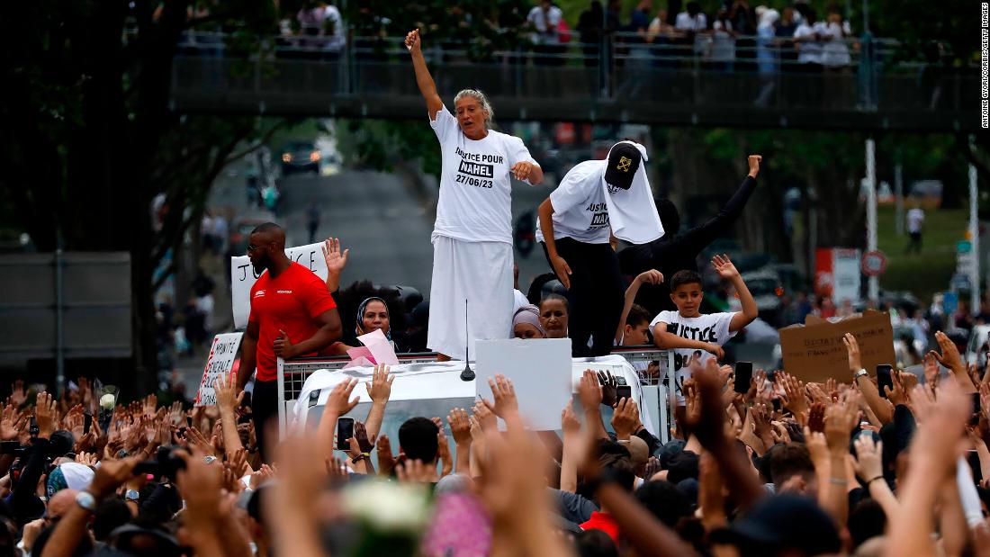 Mounia, the mother of Nahel Merzouk, gestures as she stands on a truck during a march in Nanterre on June 29.