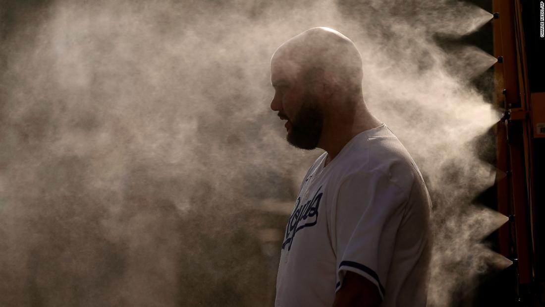 A man cools off in a mister at Kauffman Stadium before a Major League Baseball game in Kansas City, Missouri, on Wednesday, June 28.