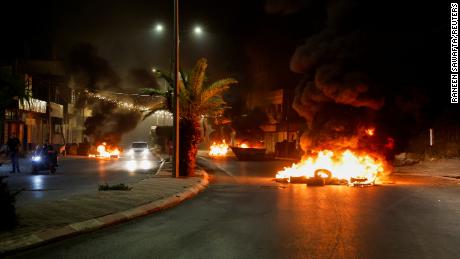 Tires were set on fire on a street during the attacks on Jenin.