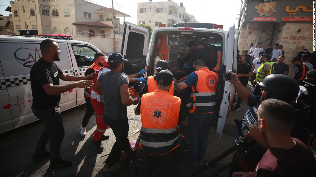 Wounded people are transferred into an ambulance for hospital treatment in Jenin on Sunday.