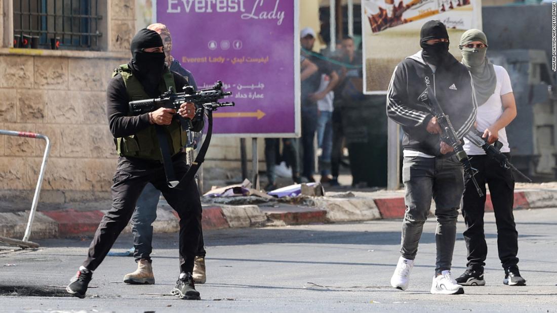 Palestinian militants take up position during a confrontation with Israeli forces in Jenin on Monday.