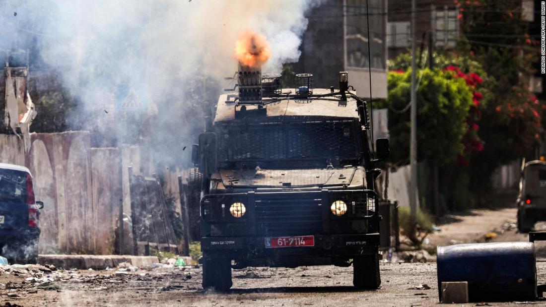 An Israeli armored vehicle fires tear gas during the military operation in Jenin on Tuesday.