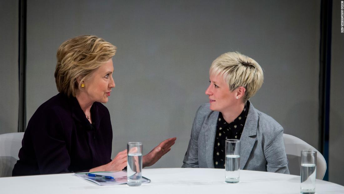 Former US Secretary of State Hillary Clinton speaks with Rapinoe during a roundtable discussion on pay equality in New York in 2016. Rapinoe has been a long-time advocate of equal pay in sport.