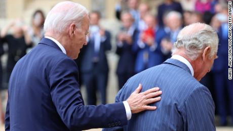 US President Joe Biden places his hand on the back of Britain&#39;s King Charles III as they walk in the Quadrangle after ceremonial welcome at Windsor Castle in Windsor on July 10, 2023. US President Joe Biden was in Britain on Monday, where he met with Prime Minister Rishi Sunak and King Charles III, before going on to a NATO summit in Lithuania. (Photo by Chris Jackson / POOL / AFP) (Photo by CHRIS JACKSON/POOL/AFP via Getty Images)