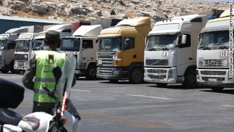 A convoy of trucks carrying humanitarian aid is seen parked after crossing the Syrian Bab al-Hawa border crossing with Turkey, on July 10, 2023.
