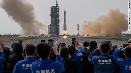 Officials from China&#39;s Manned Space Agency and visitors watch as the Shenzhou-16 spacecraft launches at the Jiuquan Satellite Launch Center on May 30, 2023, in Jiuquan, China.