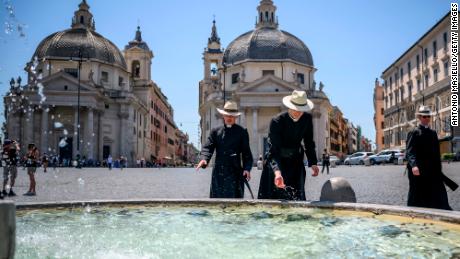 People cool off at Piazza del Popolo in Rome on July 10. 