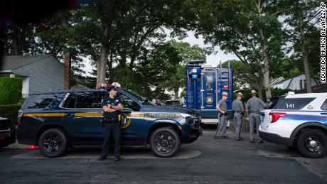 Law enforcement arrive at a house Friday, July 14, 2023, as sources said a suspect has been taken into custody in connection with a string of killings on New York&#39;s Long Island.