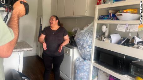 Yolanda Cendejas, a janitor laid off from Paramount Studios, shows CNN the bags of plastic bottles she&#39;s collecting for cash on June 28.