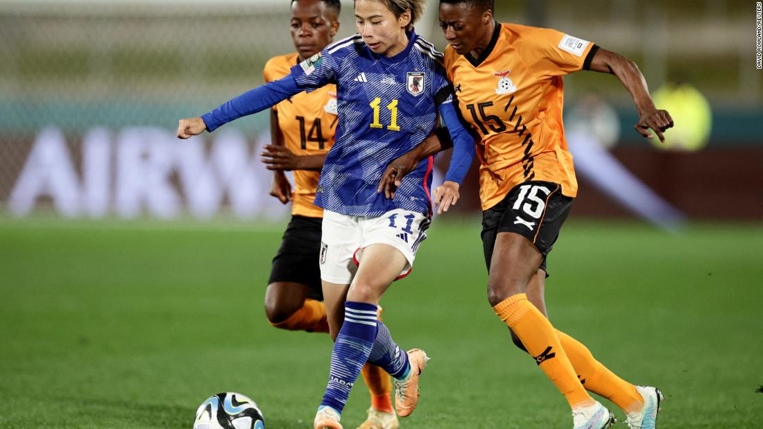 Japan&#39;s Mina Tanaka battles with Zambia&#39;s Agnes Musase.