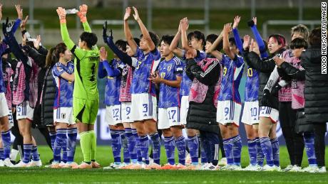 Japan&#39;s players line up and acknowledge the crowd following their 5-0 win.