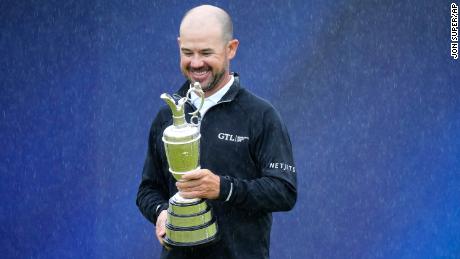 United States&#39; Brian Harman poses for the media as he holds the Claret Jug trophy for winning the British Open Golf Championships at the Royal Liverpool Golf Club in Hoylake, England, Sunday, July 23, 2023.