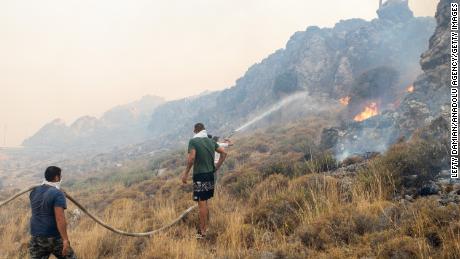 Firefighter teams intervene a wildfire across Greece&#39;s Rhodes island on July 22, 2023, as Greece grapples with a severe heat wave. 