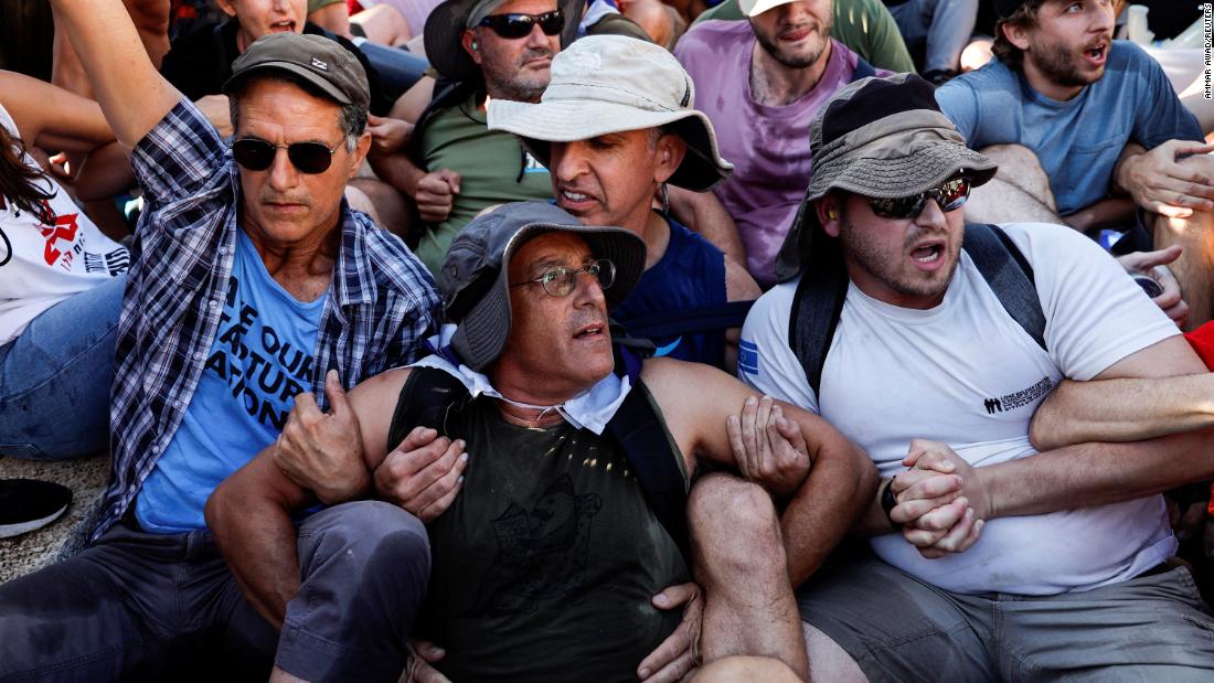 Protesters link arms as they attempt to block a road leading to the Knesset on July 24.