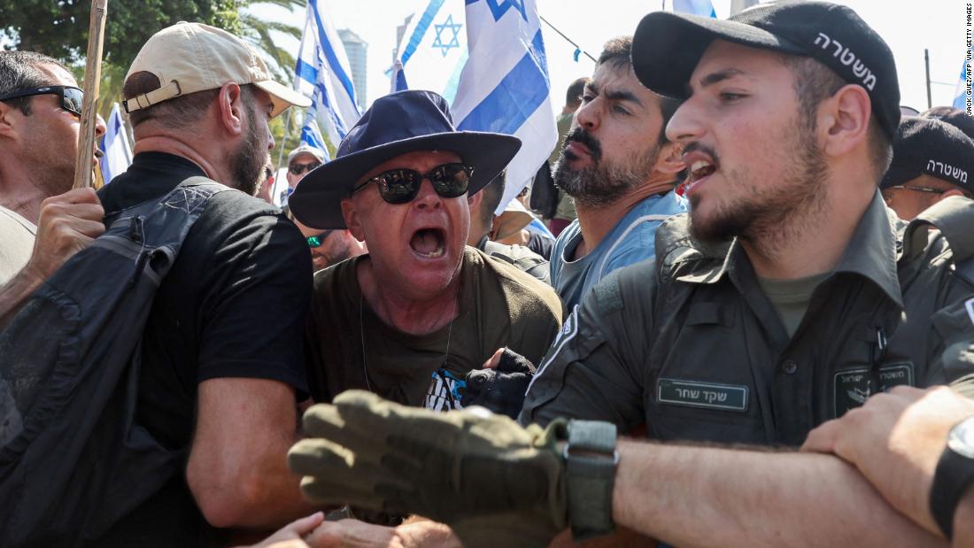 Members of Israel&#39;s security forces scuffle with demonstrators in Tel Aviv on July 18.