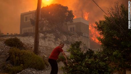 A wildfire burns in Gennadi village, on the Aegean Sea island of Rhodes, southeastern Greece, on Tuesday, July 25, 2023. 