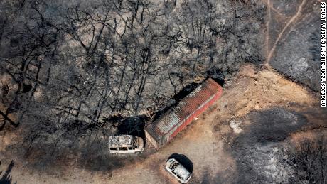 An aerial view shows burnt vehicles and trees after a fire near Vati, on Rhodes, on July 26, 2023.