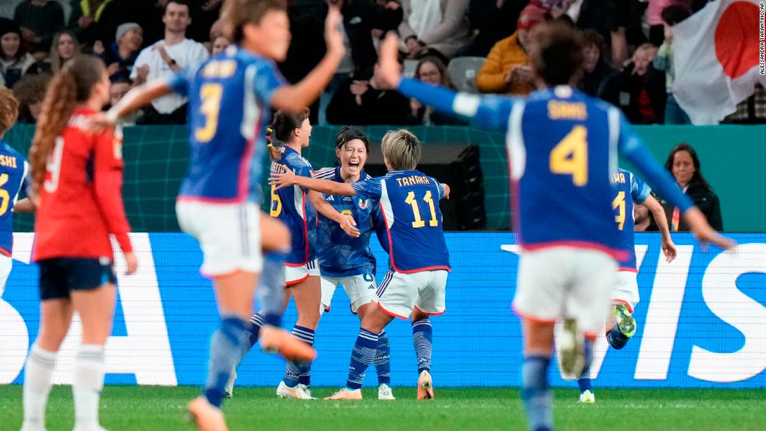 Japan&#39;s Hikaru Naomoto, center, celebrates with teammates after scoring the opening goal in the 2-0 victory over Costa Rica on July 26. It was Japan&#39;s second win in as many games, and it clinched a spot in the knockout stage.