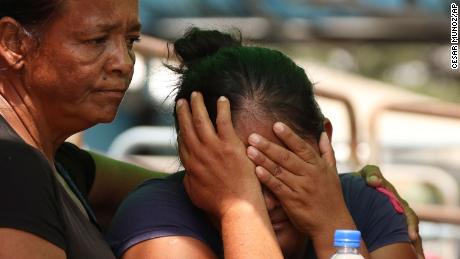 Relatives of prisoners at a penitentiary in Ecuador learn about the fatal clashes in Guayaquil on Tuesday, where dozens of bodily remains were recovered.